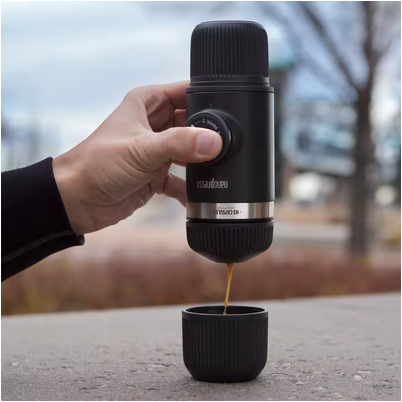 Cafetière portable Aventure Nomade verse un café à l'extérieur