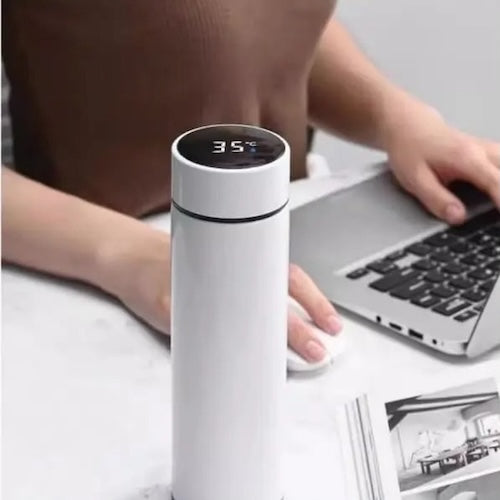 Thermos cafe portable ThermoSmart blanc sur un bureau avec ordinateur